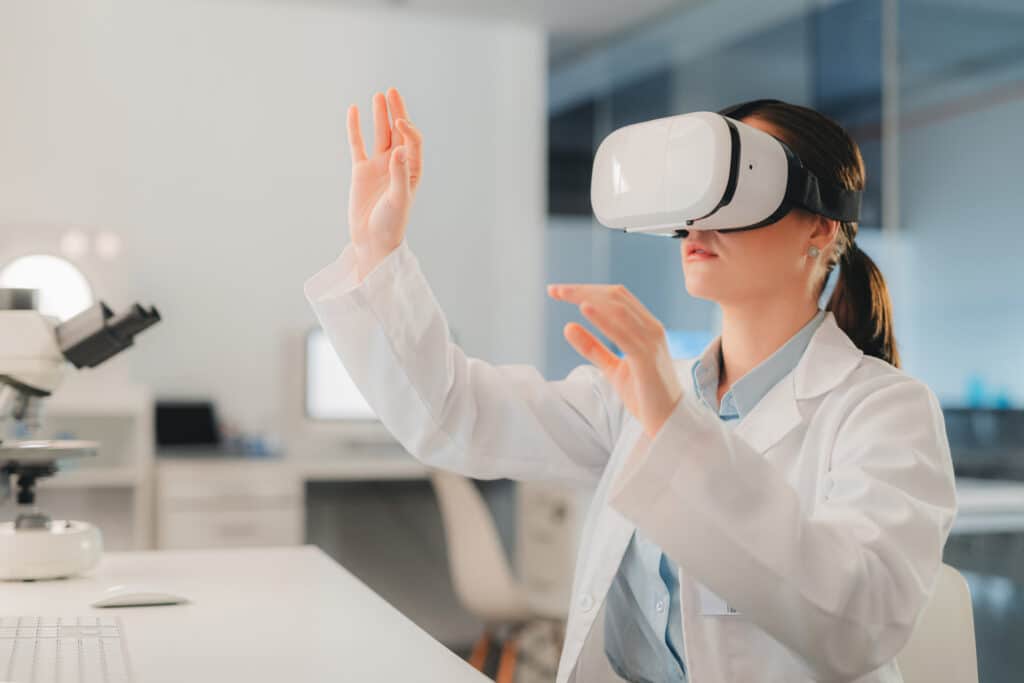 A scientist working in a laboratory wearing a virtual reality headset.