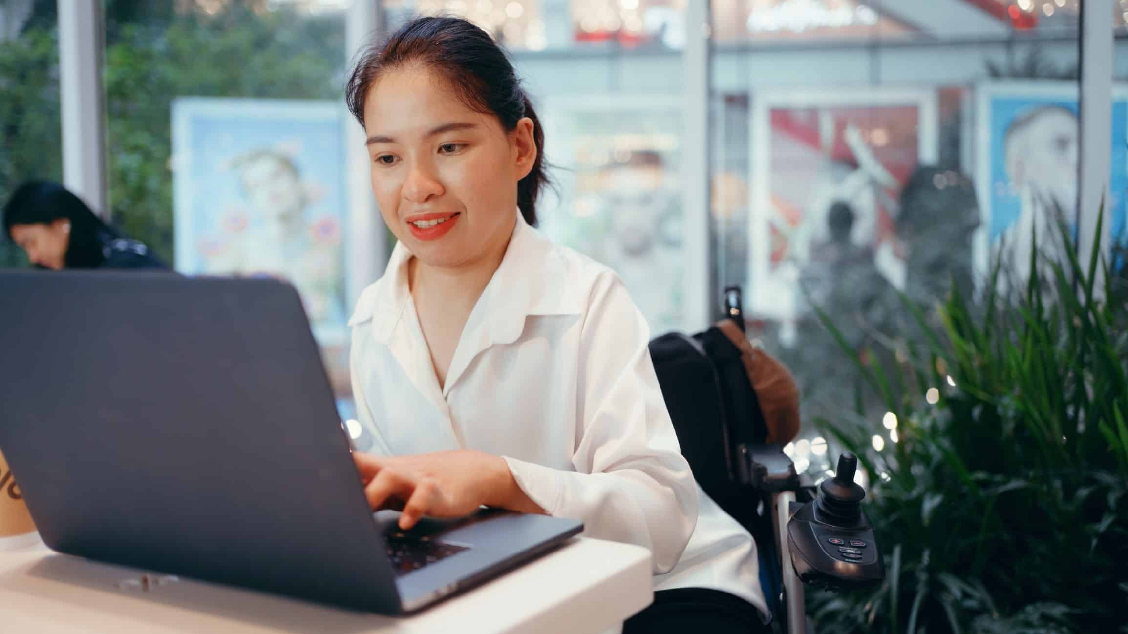 woman in wheelchair with laptop